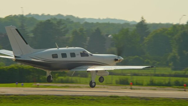 Departure of small business private single-engine plane aircraft at Municipal Airport. Business jet for corporate executive or VIP.