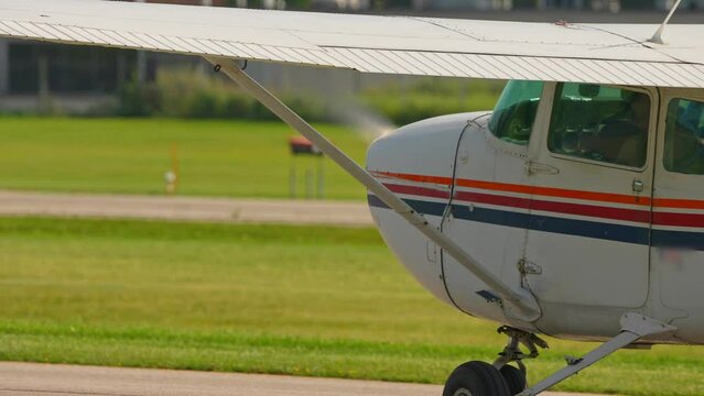 Plane engine with working propeller. Departure warm up of a small aircraft. Private single engine airplane at Municipal Airport. Flying pilot lessons and flight training for recreational pilot permit.