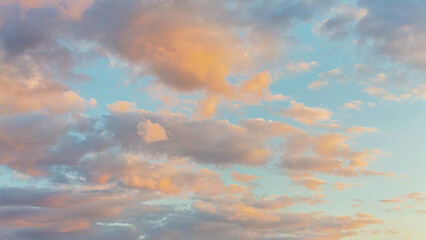 Panoramic view of clear blue sky and multicolored clouds, Blue sky background with tiny clouds. White and pearl fluffy clouds in the blue sky at sunrise. Atmosphere background or wallpaper