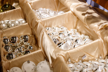 white balls for the Christmas tree in boxes. Christmas decorations. new year 2024