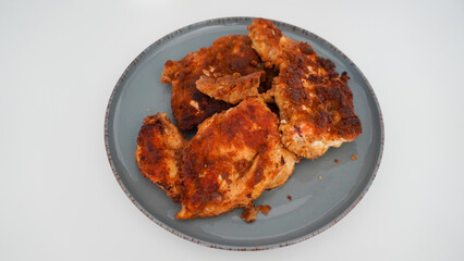 Big fried chicken pieces in a saucepan