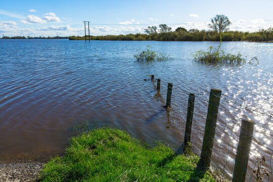 Storm Babet brings extreme flooding from the River Aire to agricultural fields alongside the Birkin, West Haddlesey Road, Selby, North Yorkshire in October 2023.  Horizontal.  Space for copy.