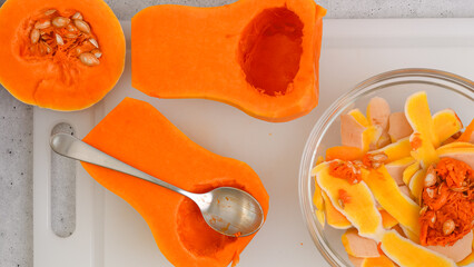 Butternut squash soup recipe. Raw vegetables close-up on the kitchen table. Peeled  and seedless...