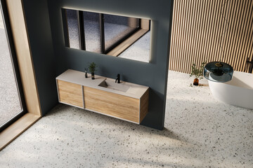 Comfortable bathtub and vanity with basin standing in modern bathroom dark blue and wooden walls and terrazzo floor