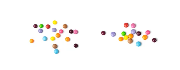 Tuinposter Scattered small candies isolated. Colorful dragees, multicolored glazed chocolate buttons © ange1011