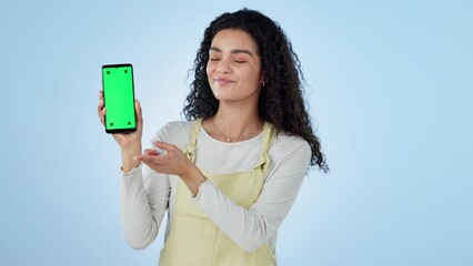 Face, happy woman or advertising green screen of phone, space or thumbs up for agreement, offer or deal on blue background. Portrait, mobile and yes to announcement, newsletter or promotion in studio