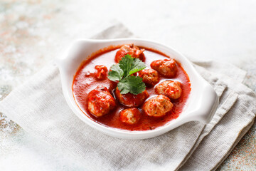 Chicken meatballs with tomato sauce.