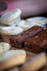 Chocolate brownies and mince pies for sale on a market stall, with a shallow depth of field