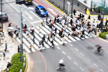 crowds of people crossing a city street in Tokyo, Japan