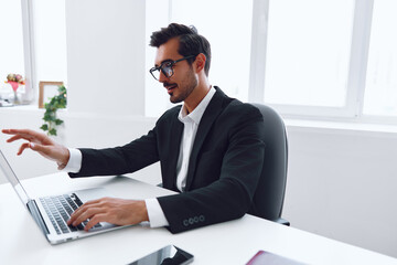 Fototapeta premium Man job office happy business businessman winner lifestyle suit white young technology laptop