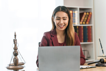 Young Asian female lawyer people reviewing legal documents at desk, embodying reliability,...