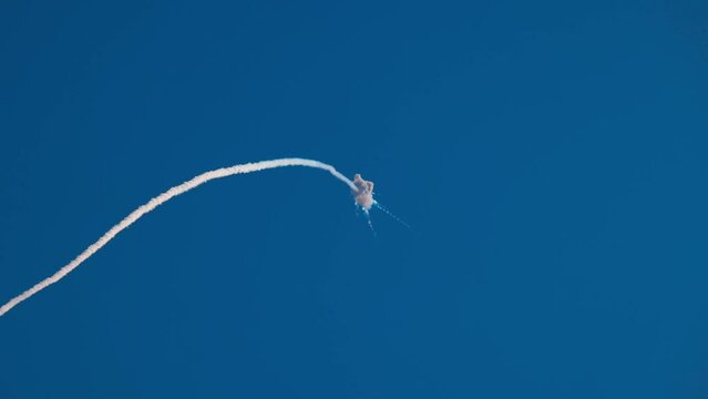Missile attack, explosion in the air. An anti-aircraft missile has hit its target in the blue sky. Air defence. Shot down, war in the sky. Smoke in the sky after air missile SAM. Slow motion video