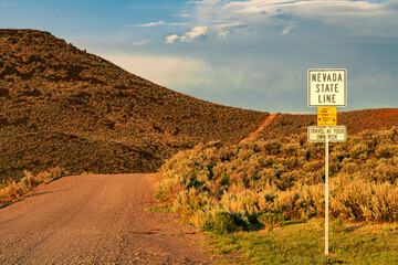 Sign on a remote dirt road in the Smoke Creek Desert of Lassen County California, alerting...