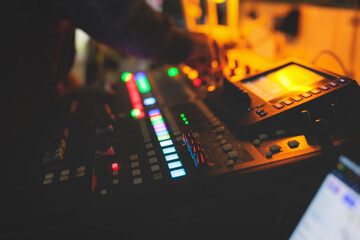 View of lighting technician operator working on mixing console workplace during live conference...