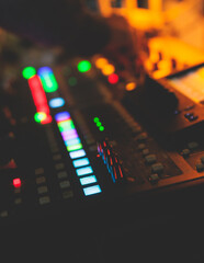View of lighting technician operator working on mixing console workplace during live conference...