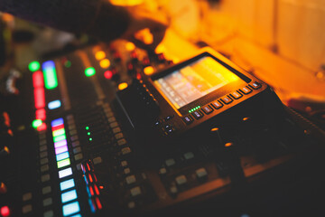 View of lighting technician operator working on mixing console workplace during live conference...