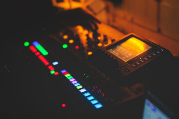 View of lighting technician operator working on mixing console workplace during live conference...