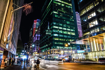 Night Time on the 6th Avenue, with the Empire State Building Reflected on Salesforce Tower -...