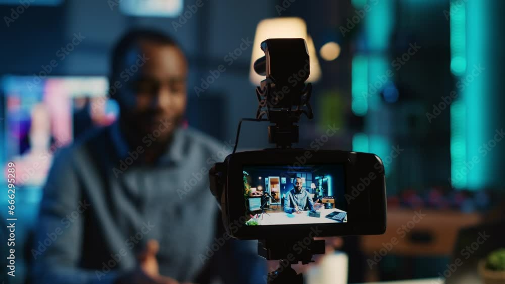 Poster close up on professional camera capturing content creator filming review of v mount battery unpackin