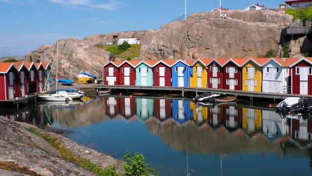 Idyllic colorful fisherman cabins Smogenbryggan in Smogen, Sweden. Typical Swedish wooden house constructions. Pan right.