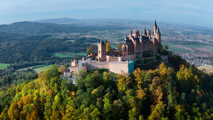 Aerial drone view of medieval Hohenzollern castle on top of hill in autumn, Baden-Wurttemberg, Germany