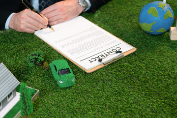 Businessman or CEO in office signing environmental regulation agreement to save Earth with...