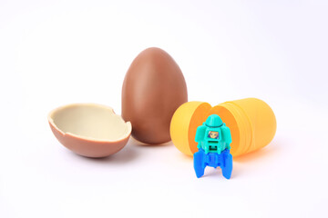Slynchev Bryag, Bulgaria - May 24, 2023: Halves of Kinder Surprise Egg, plastic capsule and toy space rocket isolated on white