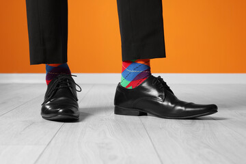 Man wearing stylish shoes and colorful socks indoors, closeup