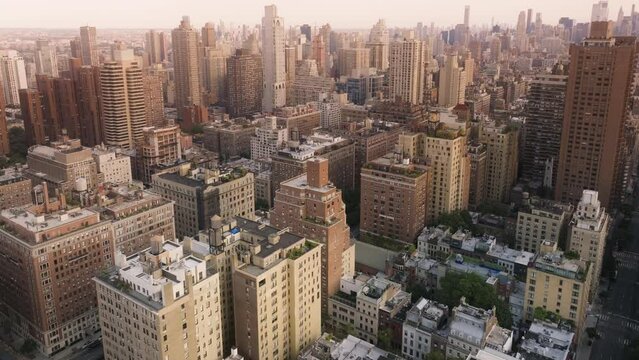 Epic aerial with cinematic Upper East side panorama. Prestige luxury real estate properties and business offices in skyscrapers on Manhattan. Scenic New York City views in warm sepia colors background