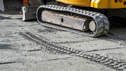 Excavator track on a gravel surface