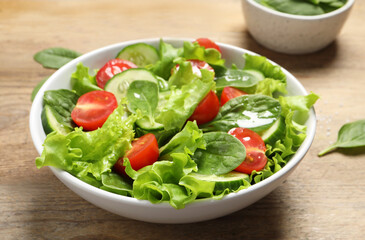 Delicious vegetable salad on wooden table, closeup