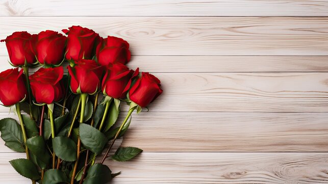 A bouquet of red roses on a light wooden background