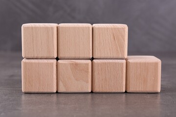 Wooden cubes with abbreviation ISO and number 9001 on grey textured table