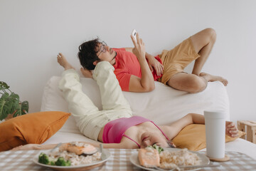 Funny asian bored couple in the living room in concept of boring life.