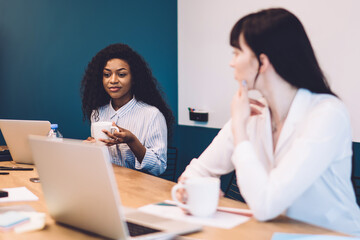 Multiracial coworkers having coffee break in office