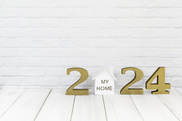 2024 new year and home  on white wood table over white background with copy space , Real estate...