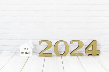2024 new year and home  on white wood table over white background with copy space , Real estate concept