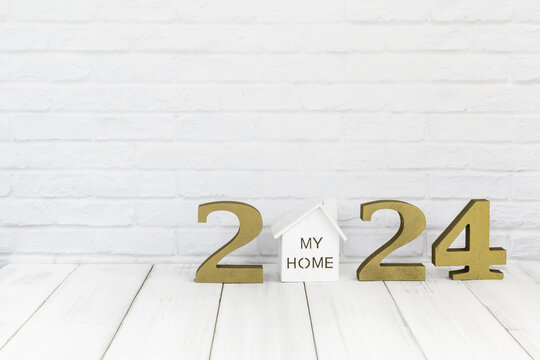 2024 new year and home  on white wood table over white background with copy space , Real estate concept
