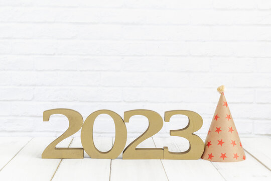 2023 new year and party hat on white wood table over white background with copy space