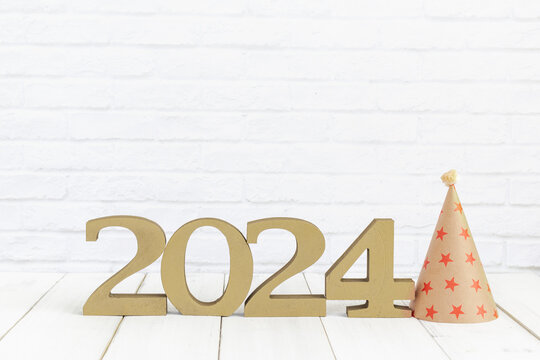 2024 new year and party hat on white wood table over white background with copy space