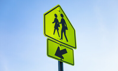Pedestrian sign in urban street. Vibrant crosswalk symbol, city life, safety concept. Busy pedestrian zone. Traffic symbol in modern city