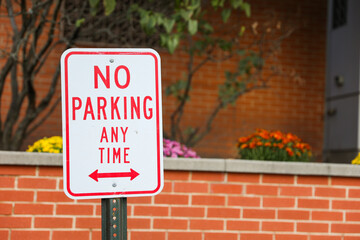 No Parking sign against a city backdrop, symbolizing urban restrictions and traffic control, with...