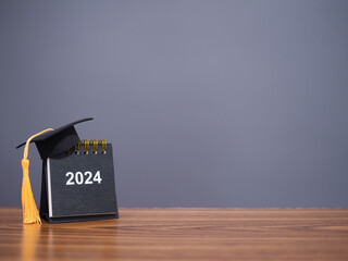 Study goals, 2024 Desk calendar with graduation hat. The concept for Resolution, Goal, Action,...