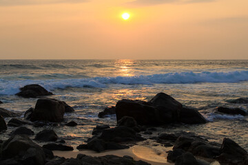 Unawatuna beach in Sri Lanka. Waves crashing on the rocks