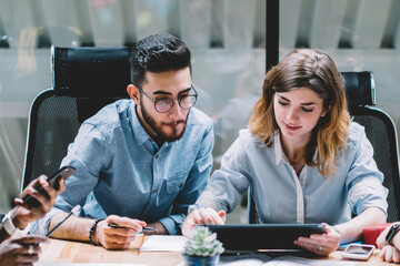  four young employees brainstorming and sharing opinions