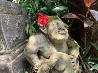Beautiful artistic Bali stone statue of a Balinese ancient garden statue used as garden decoration, javanese gnome indonesia