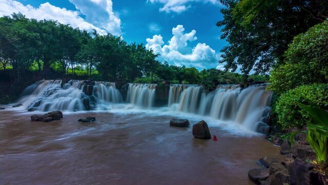 Timelapse of beautiful waterfall in Ecotourism with water flowing smooth as silk on a sunny summer day