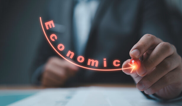 Businessman using pen to drawing red decrease arrow with economic wording for global economy depression from inflation , debt , commodity and interest increasing concept.