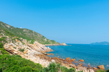 Scenic view of coastline against blue sky