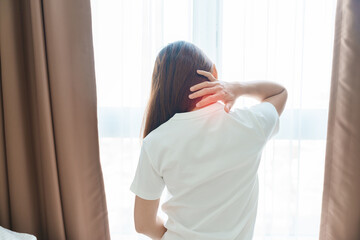 Woman having Neck and Shoulder pain during sitting on bed at home. Muscle painful due to Myofascial pain syndrome and Fibromyalgia, rheumatism, Scapular pain, Cervical Spine. Waking and Health concept